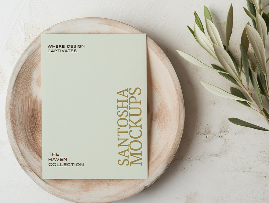 Studio Santosha HAVEN Collection A4 card mockup styled on a round wooden plate with olive branch and soft neutral background tones.