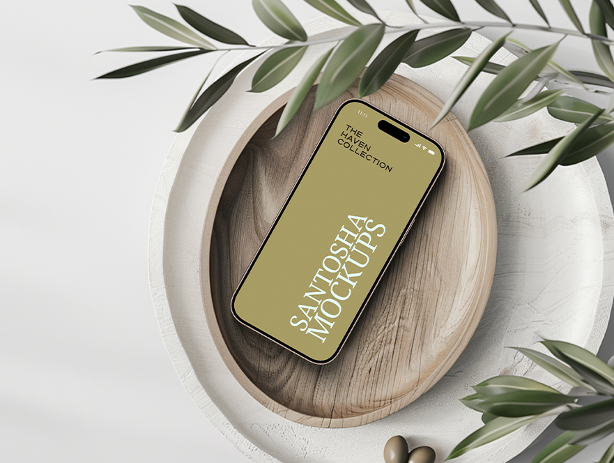 Studio Santosha HAVEN Collection iPhone mockup displayed in a round wooden bowl, styled with olive branch details and soft natural light.