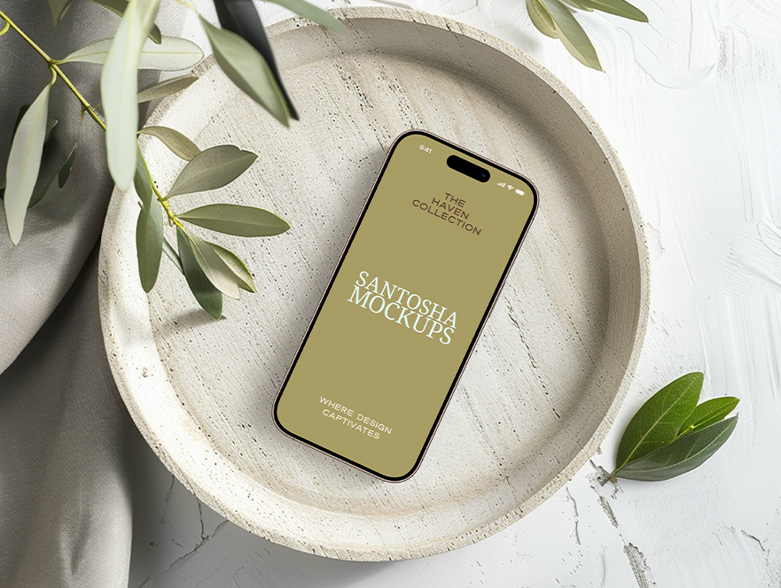 Studio Santosha HAVEN Collection iPhone mockup displayed on a white ceramic plate, styled with olive branch and soft neutral textures in natural light.
