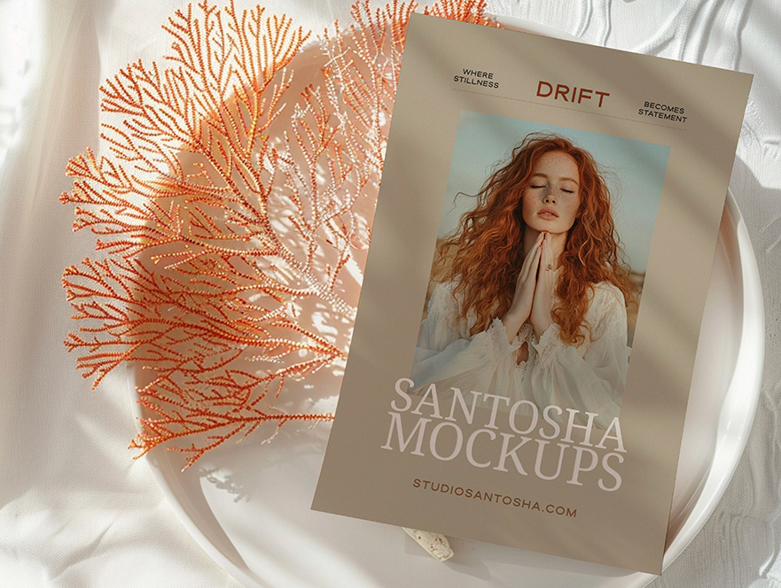 A4 paper mockup from the DRIFT Collection by Studio Santosha, displayed on a soft fabric surface with coral decoration and natural light shadows.