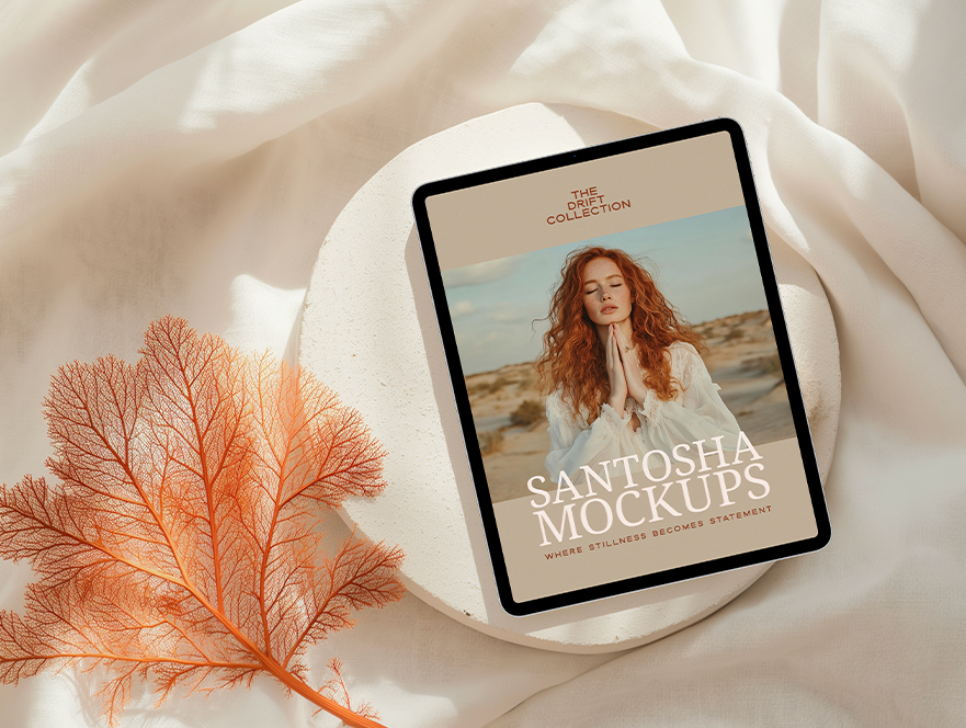 iPad mockup from the DRIFT Collection by Studio Santosha, displayed on a soft fabric surface with coral decoration and natural shadows.