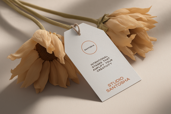 Hang tag mockup from the Studio Santosha Solo Edit called Sunform, featuring minimalist branding on textured cardstock with natural twine, styled beside soft dried flowers in warm neutral light.