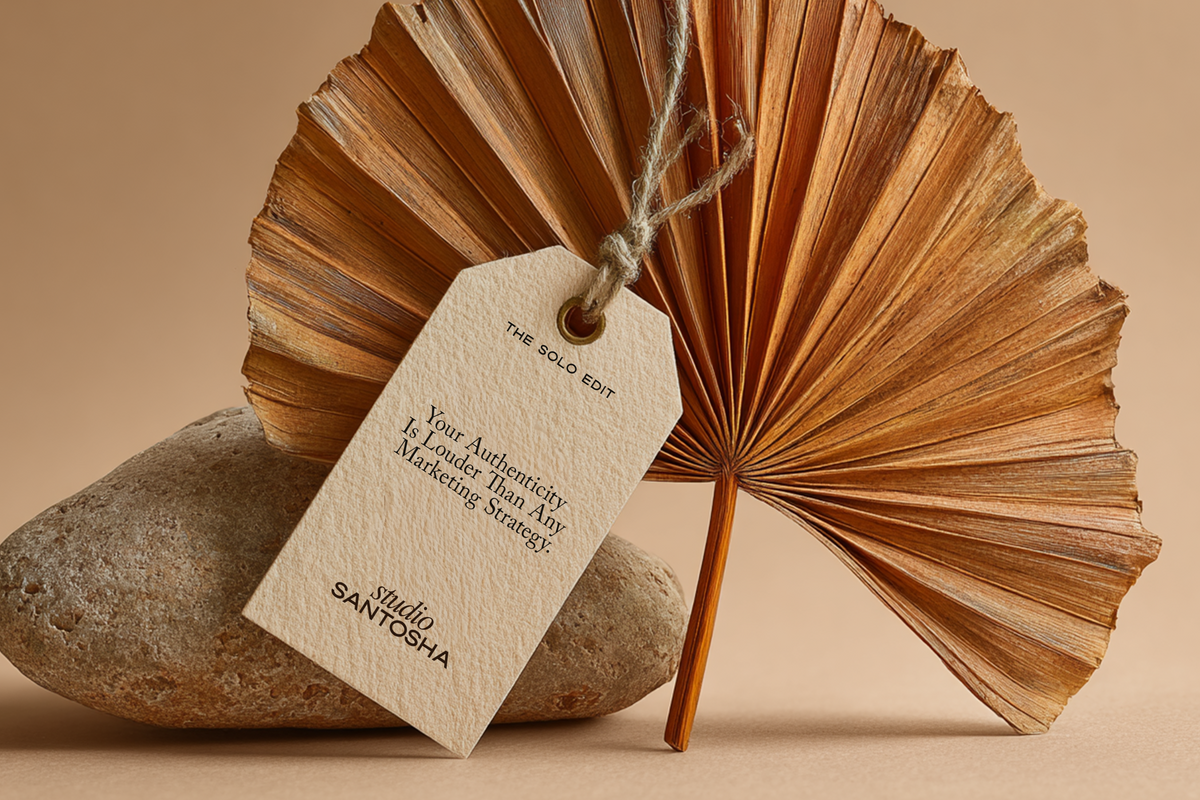 Palm leaf and hanging paper tag mockup from the Palmstone Solo Edit Collection by Studio Santosha on natural stone with warm beige background