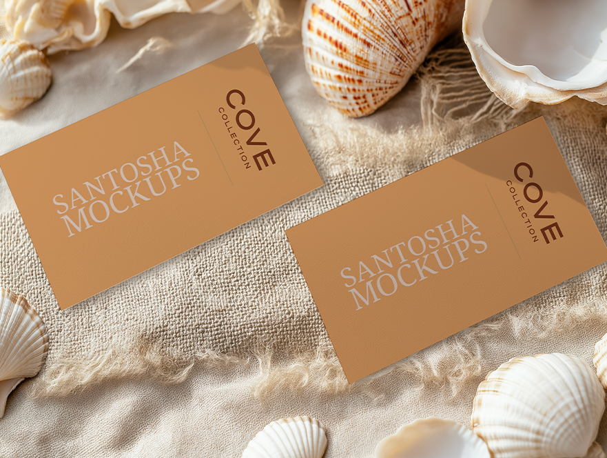 Studio Santosha Cove Collection mockup featuring two business cards on a woven coastal fabric with seashell accents