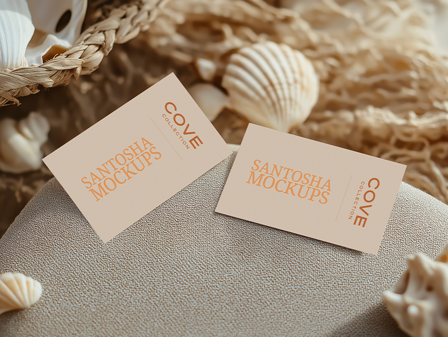 Cove Collection business card mockups by Studio Santosha on a textured surface, styled with seashells and woven basket accents