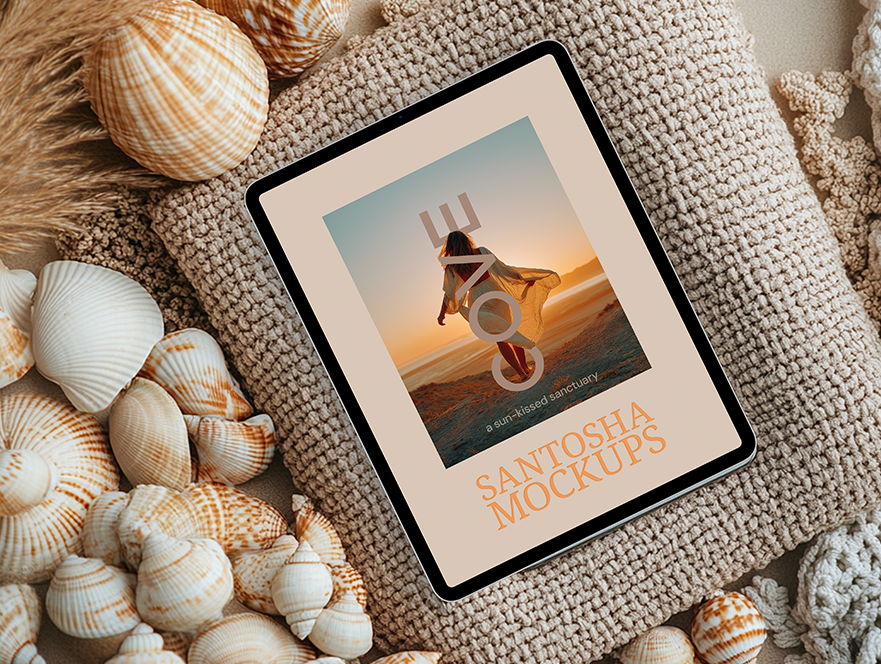 Cove Collection tablet mockup by Studio Santosha featuring a woman walking on the beach, displayed on a woven textured cushion surrounded by seashells