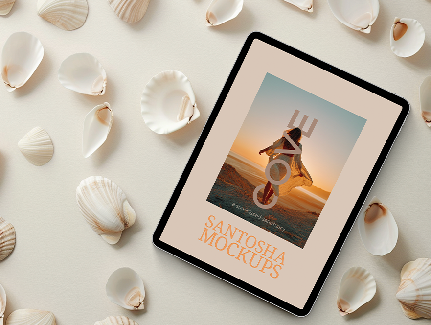 Tablet mockup from Studio Santosha's Cove Collection, featuring a coastal-themed design surrounded by scattered seashells on a light background