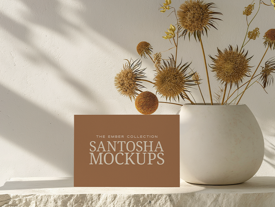 Horizontal business card mockup on textured stone surface with strong natural shadows, from the Studio Santosha EMBER Collection.