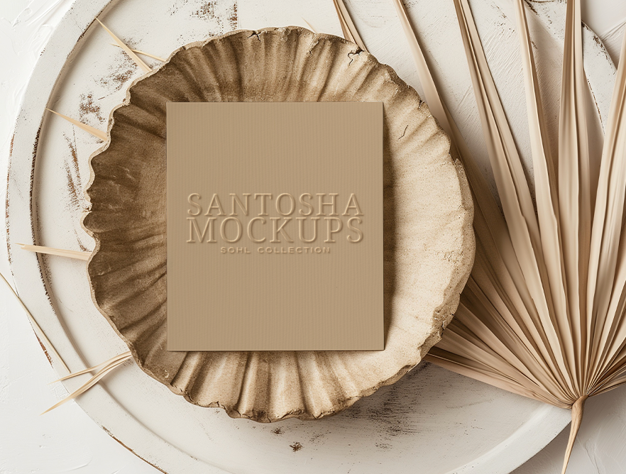 4x6 card mockup from the SOHL Collection by Studio Santosha — beige embossed card styled on a decorative plate with dried palm leaves in soft neutral light.