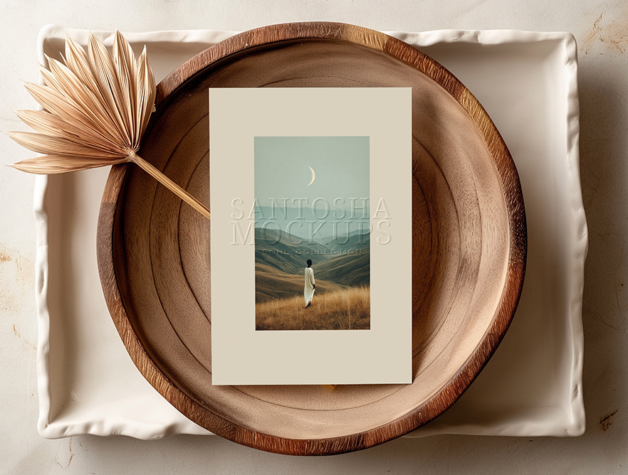 A4 card mockup from the SOHL Collection by Studio Santosha — framed artwork displayed on a round wooden tray with a dried palm leaf, styled in soft natural light.