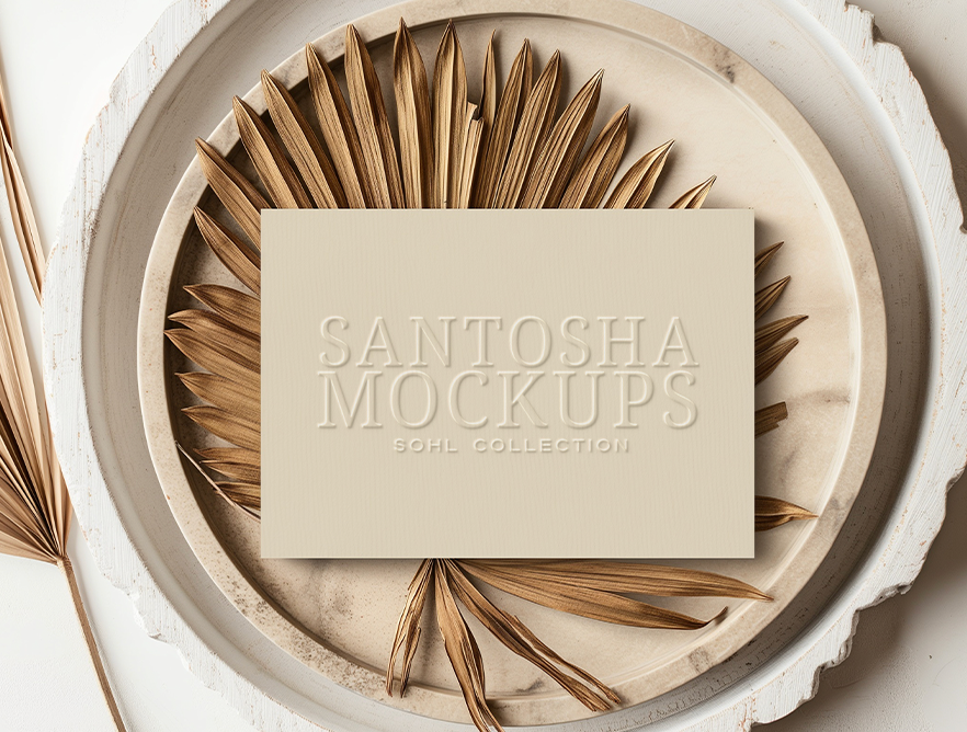 Flat business card mockup from the SOHL Collection by Studio Santosha, embossed card styled on dried palm leaves and a decorative plate with soft natural shadows.
