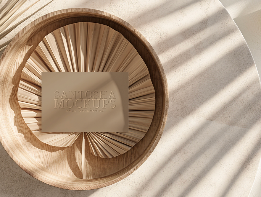 Business card mockup from the SOHL Collection by Studio Santosha, embossed card styled on folded palm textures in a wooden bowl with soft shadows and natural light.