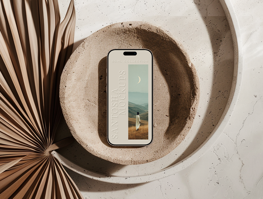 iPhone mockup from the SOHL Collection by Studio Santosha — placed inside a textured stone tray on a marble surface, styled with dried palm fronds in natural sunlight