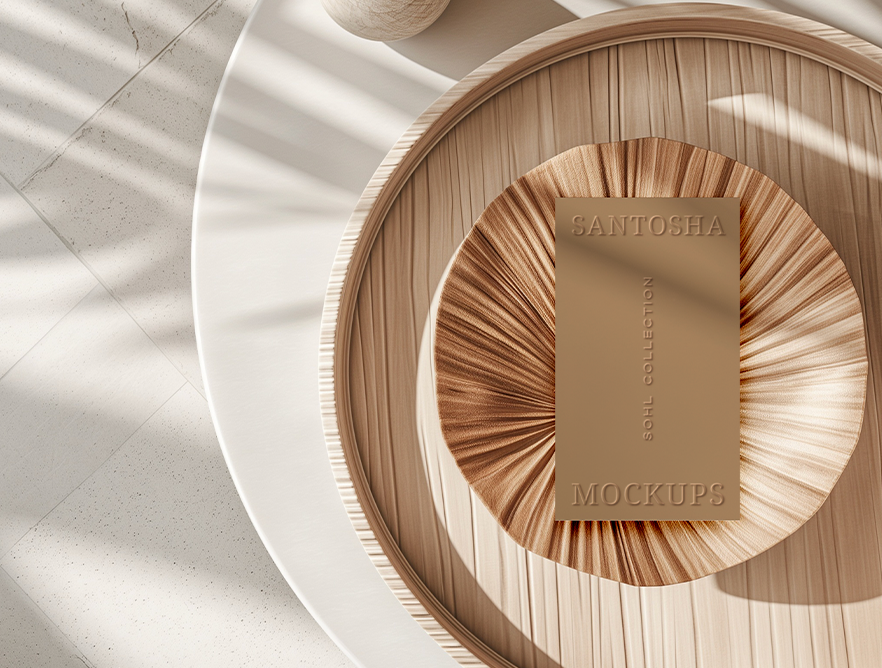 Vertical business card mockup from the SOHL Collection by Studio Santosha, embossed card styled on folded palm textures in a wooden bowl with soft natural light.